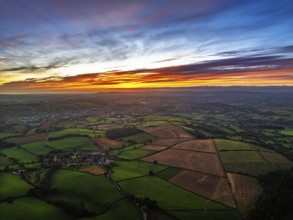 Sunset of Devon Farms and Fields over Berry Pomeroy from a drone, Totnes, England, United Kingdom