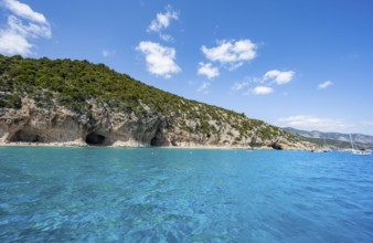 Clear blue water and picturesque rocky coast, Cala Luna cliffs and beach, Golfo di Orosei, Baunei,