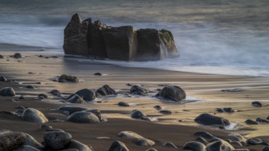 Sunset, waves and rocks in the sea, Praia Formosa, Madeira, Portugal