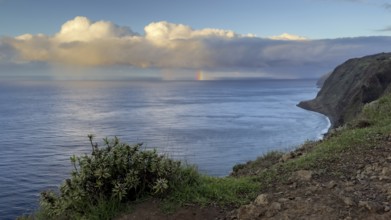 Sunset, rainbow over sea, at Farol da Ponta do Pargo lighthouse, west coast, Madeira, Portugal