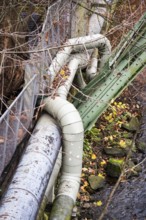 District heating pipeline in front of old industrial buildings on the banks of the Wupper,