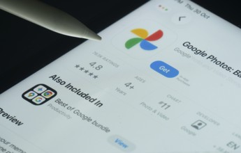 Dhaka, Bangladesh- 30 Oct 2025: Google Photos app on a iPad screen with a pen pointing at the