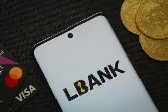 Dhaka, Bangladesh- 06 Sep 2025: Smartphone displaying Lbank logo surrounded by Bitcoin coins and
