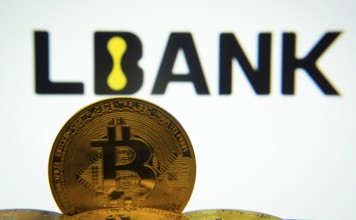 Dhaka, Bangladesh- 03 Sep 2025: Close-up of Bitcoin coins with the LBank logo visible on a screen