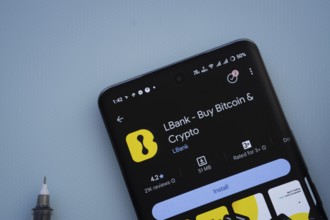 Dhaka, Bangladesh- 29 May 2025: On a blue surface, a smartphone displays the LBank app within the