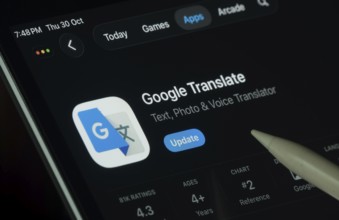 Dhaka, Bangladesh- 30 Oct 2025: Google Translate app displayed on a iPad screen in dark mode with a