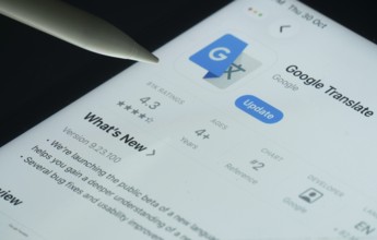 Dhaka, Bangladesh- 30 Oct 2025: Google Translate app on a iPad screen with a pen pointing at the