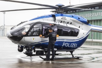 Helicopter from the Baden-Württemberg Police team in front of the hangar at the airport. Airbus