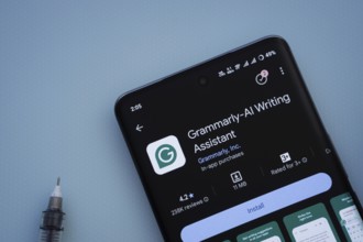 Dhaka, Bangladesh- 29 May 2025: On a blue surface, a smartphone displays the Grammarly app within