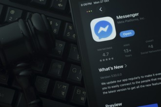 Dhaka, Bangladesh- 28 Oct 2025: An iPad displaying the Messenger app against a judge's gavel and