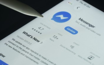 Dhaka, Bangladesh- 30 Oct 2025: Facebook Messenger app on a iPad screen with a pen pointing at the