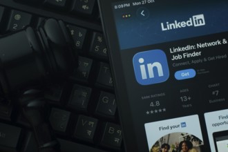 Dhaka, Bangladesh- 28 Oct 2025: An iPad displaying the LinkedIn app against a judge's gavel and