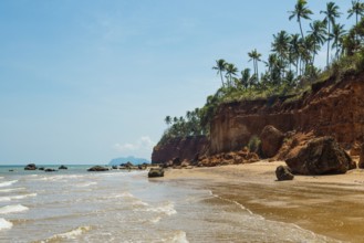 Lonely beach with red rocks and coconut trees, Red Cliffs, Bang Saphan Noi, Prachuap Khiri Khan
