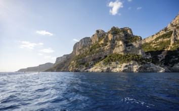 Picturesque rocky coast, cliffs in morning light, blue sea, Golfo di Orosei, Baunei, Sardinia,