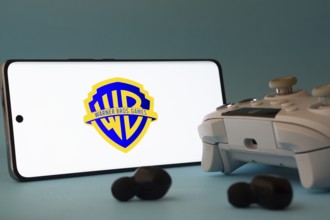 Dhaka, Bangladesh- 23 Mar 2025: A smartphone with a Warner Bros. Games icon next to a controller