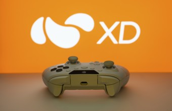 Dhaka, Bangladesh- 14 Nov 2025: A close-up of a white gamepad with the XD seen on screen in the