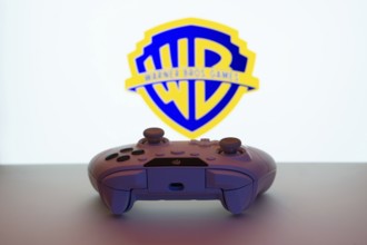 Dhaka, Bangladesh- 14 Nov 2025: A close-up of a white gamepad with the Warner Bros. Games seen on