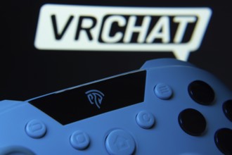 Dhaka, Bangladesh- 14 Nov 2025: A close-up of a gamepad with the VRChat seen on screen in the