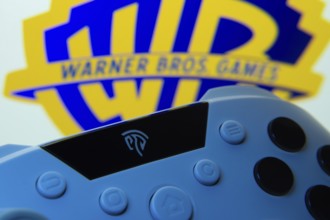 Dhaka, Bangladesh- 14 Nov 2025: A close-up of a gamepad with the Warner Bros. Games seen on screen