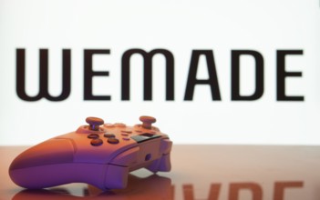 Dhaka, Bangladesh- 14 Nov 2025: A close-up of a white gamepad with the WeMade Entertainment seen on