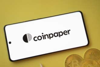 Dhaka, Bangladesh- 19 Sep 2025: Coinpaper logo on smartphone screen near Bitcoin coin and QR code