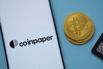 Dhaka, Bangladesh- 03 Sep 2025: Coinpaper logo on smartphone screen near Bitcoin coin and QR code
