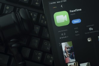 Dhaka, Bangladesh- 28 Oct 2025: An iPad displaying the Apple Facetime app against a judge's gavel