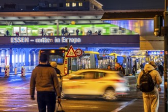 The main train station in Essen, blue illuminated underpass, bus station, am Europaplatz, train on