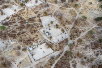 Settlement, simple house and fence, dry savanna landscape, near Maun, aerial view, Okavango Delta,