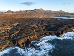 Coast with lava fields, volcanic landscape near Los Hervideros, in the evening light, aerial view,