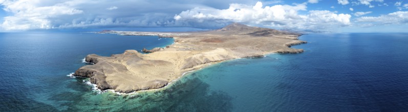 Headland and blue sea, coastal landscape, arid landscape of Los Ajaches Natural Park, aerial view,