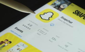 Dhaka, Bangladesh- 30 Oct 2025: Snapchat app on a iPad screen with a pen pointing at the install