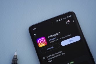 Dhaka, Bangladesh- 29 May 2025: On a blue surface, a smartphone displays the Instagram app within