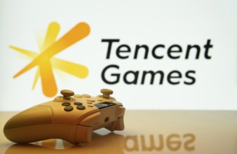 Dhaka, Bangladesh- 14 Nov 2025: A close-up of a white gamepad with the Tencent Games seen on screen