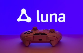 Dhaka, Bangladesh- 14 Nov 2025: A close-up of a white gamepad with the Amazon Luna seen on screen