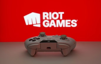 Dhaka, Bangladesh- 14 Nov 2025: A close-up of a white gamepad with the Riot Games seen on screen in