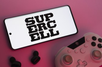 Dhaka, Bangladesh- 22 Mar 2025: Smartphone with Supercell logo, game controller, and earbuds on a