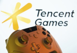 Dhaka, Bangladesh- 14 Nov 2025: A close-up of a gamepad with the Tencent Games seen on screen in
