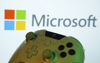 Dhaka, Bangladesh- 14 Nov 2025: A close-up of a gamepad with the Microsoft seen on screen in the