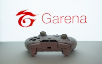 Dhaka, Bangladesh- 19 Sep 2025: A close-up of a white gamepad with the Garena seen on screen in the