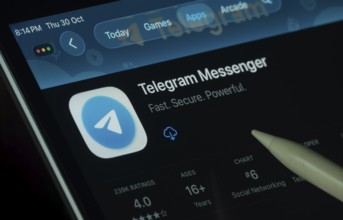 Dhaka, Bangladesh- 30 Oct 2025: Telegram app displayed on a iPad screen in dark mode with a digital