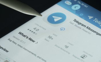 Dhaka, Bangladesh- 30 Oct 2025: Telegram app on a iPad screen with a pen pointing at the install