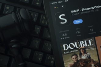 Dhaka, Bangladesh- 28 Oct 2025: An iPad displaying the SHEIN app against a judge's gavel and dark