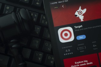 Dhaka, Bangladesh- 28 Oct 2025: An iPad displaying the Target app against a judge's gavel and dark