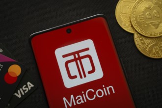 Dhaka, Bangladesh- 06 Sep 2025: Smartphone displaying MaiCoin logo surrounded by Bitcoin coins and