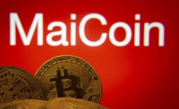 Dhaka, Bangladesh- 03 Sep 2025: Close-up of Bitcoin coins with the MaiCoin logo visible on a screen