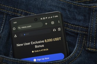 Dhaka, Bangladesh- 15 June 2025: A smartphone displaying the MEXC web interface peeks out of a