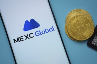 Dhaka, Bangladesh- 03 Sep 2025: MEXC Global logo on smartphone screen near Bitcoin coin and QR code