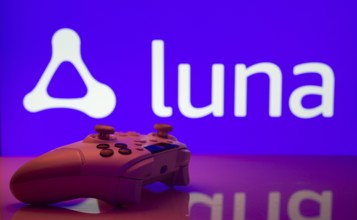 Dhaka, Bangladesh- 14 Nov 2025: A close-up of a white gamepad with the Amazon Luna seen on screen