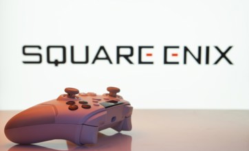 Dhaka, Bangladesh- 14 Nov 2025: A close-up of a white gamepad with the Square Enix seen on screen